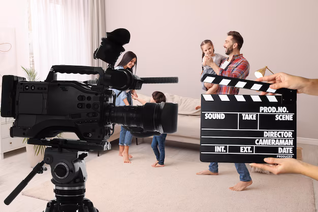 shooting-movie-second-assistant-camera-holding-clapperboard-near-video-camera-front-happy-family-actors-home-film-set_495423-52044